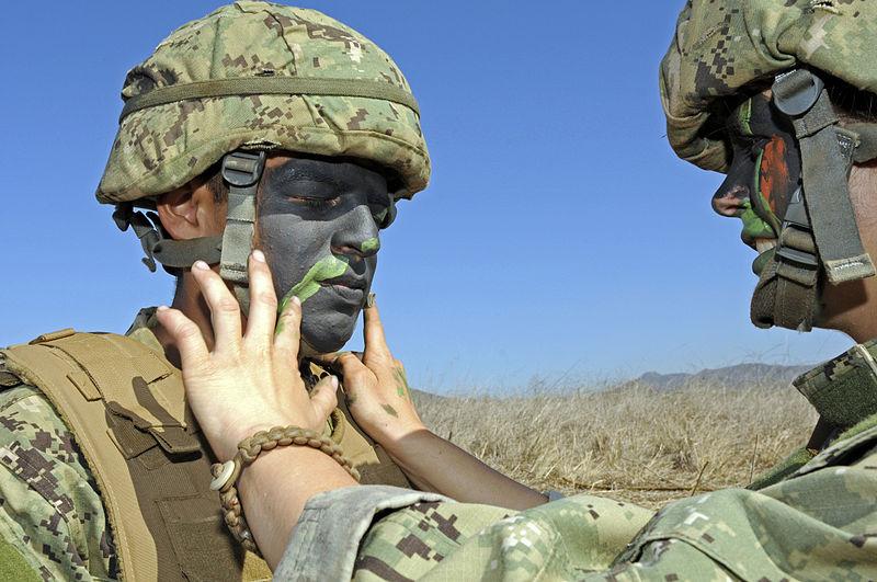 Marine Recruits camouflage their faces at Camp Pendleton.  Photograph, 2012