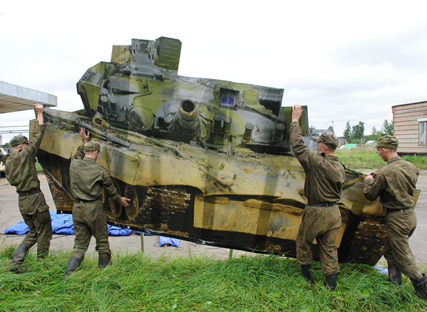 Russian troops move a “camouflaged” inflatable tank decoy into place.  Photograph 2011.